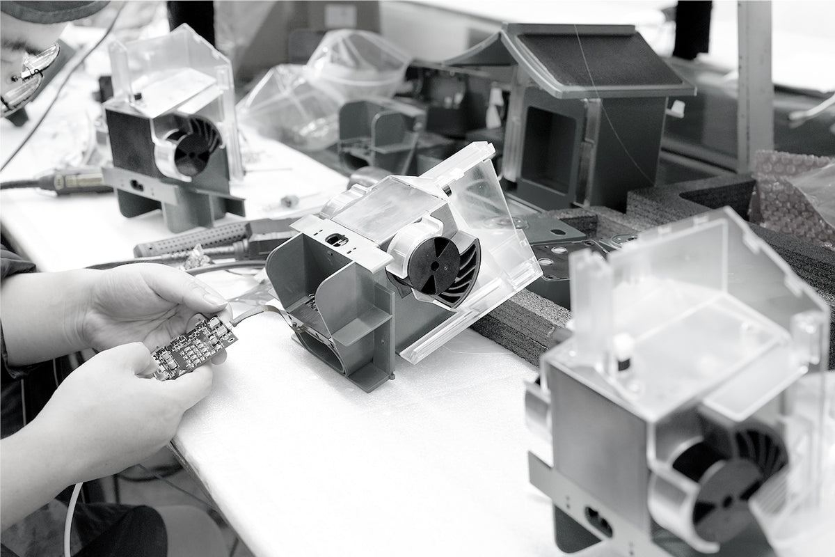 Technician assembling the BirdVue smart bird feeder