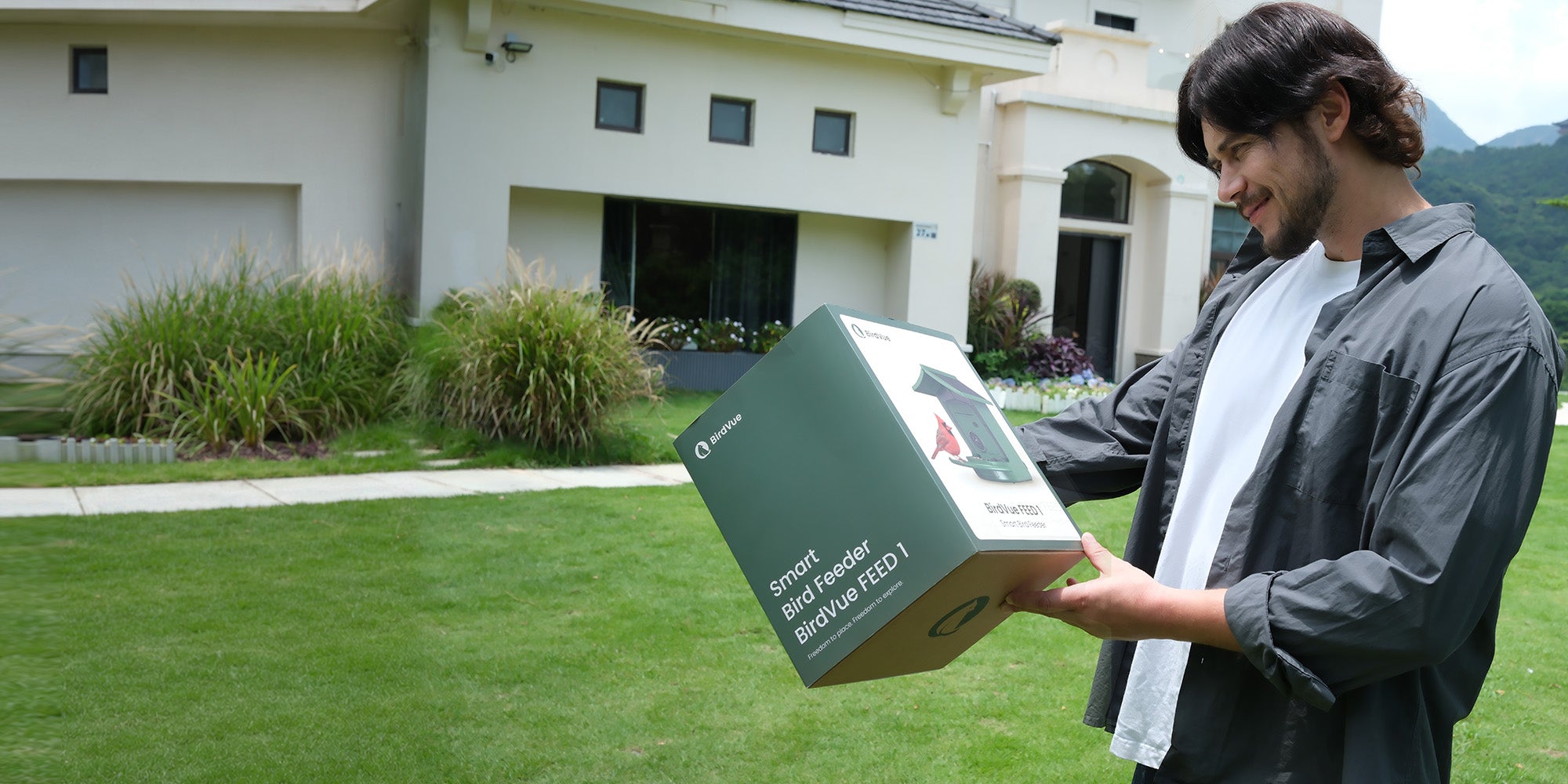 Man smiling after receiving a BirdVue smart bird feeder as a gift